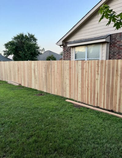 Non Stained Wooden fence running along house